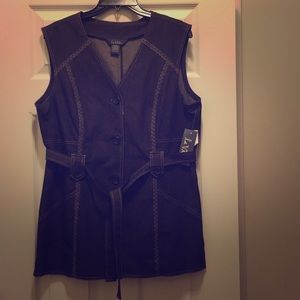 A sleeveless dark brown jean like jacket vest